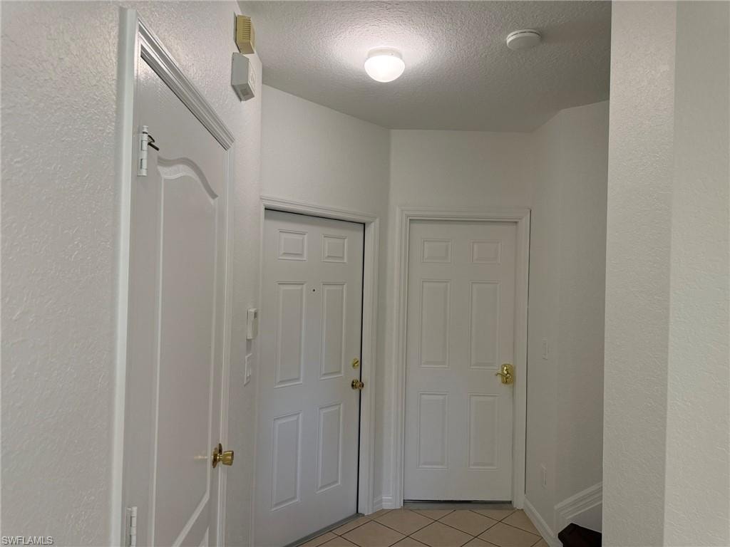 Tiled Entry Foyer. From the Right 1/s Bath, Entry Room, Door to the Garage