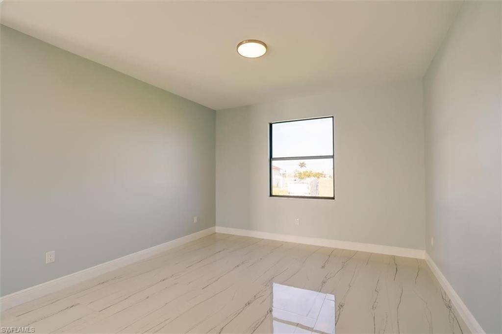 Unfurnished room featuring baseboards