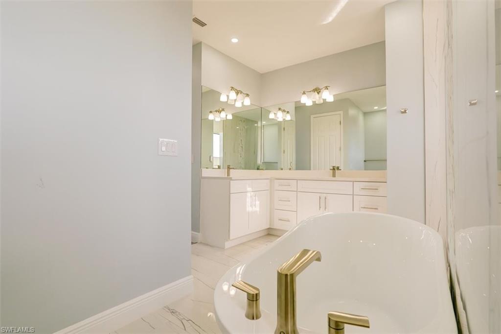 Bathroom with double vanity and a freestanding bath