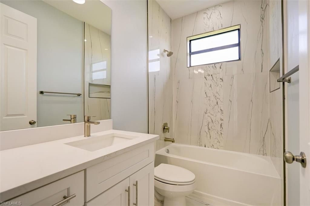 Bathroom with shower / bathtub combination and vanity