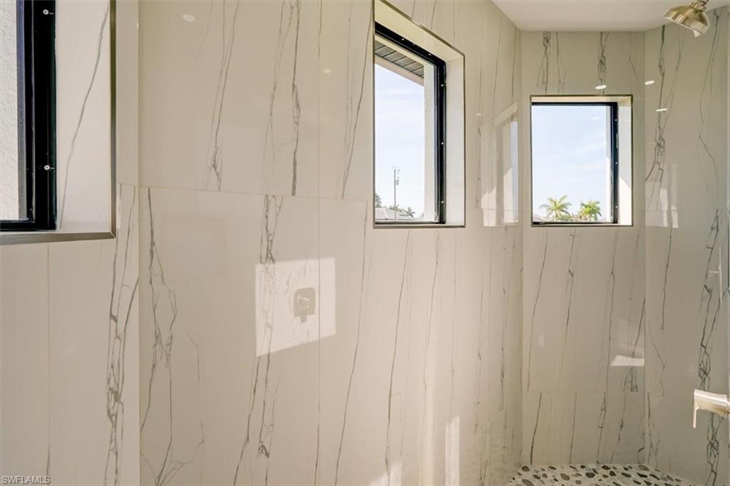 Bathroom with a marble finish shower