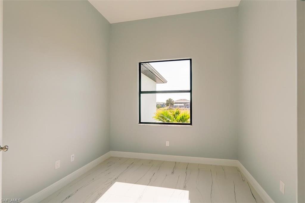 Empty room featuring baseboards
