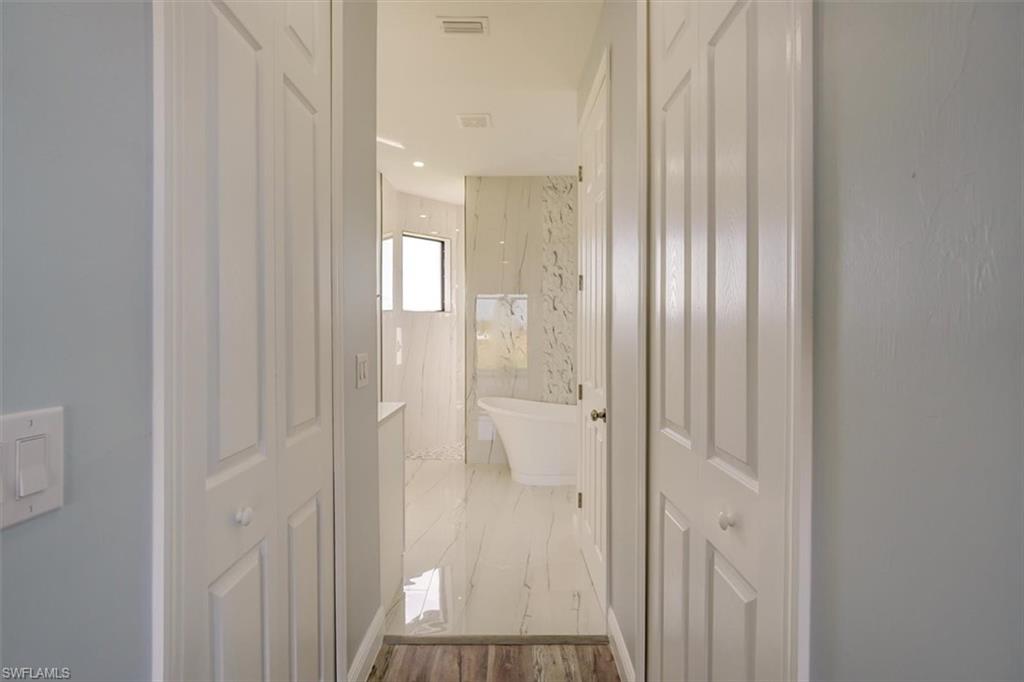 Full bath featuring a freestanding tub, a marble finish shower, and recessed lighting