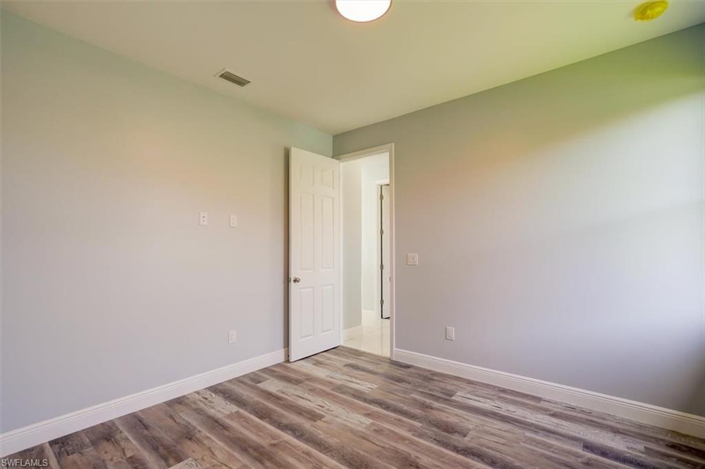 Spare room with wood finished floors and a smoke detector