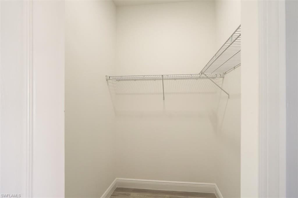 Spacious closet featuring wood finished floors