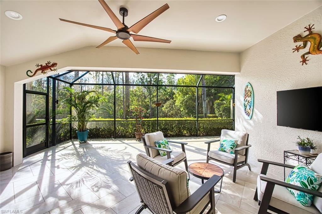 View of patio with a sunroom, outdoor lounge area, a lanai, and ceiling fan