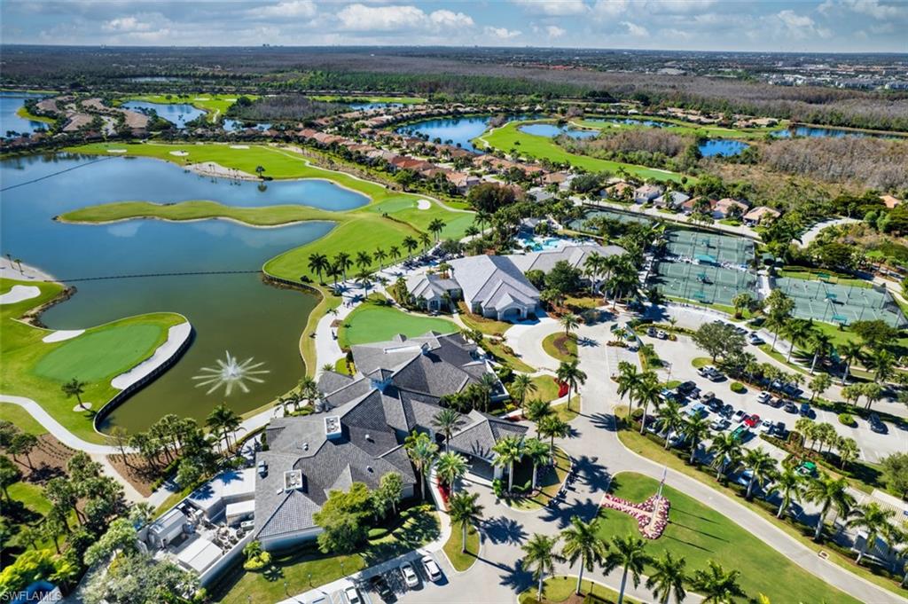 Aerial view of residential area with a local golf course and a nearby body of water