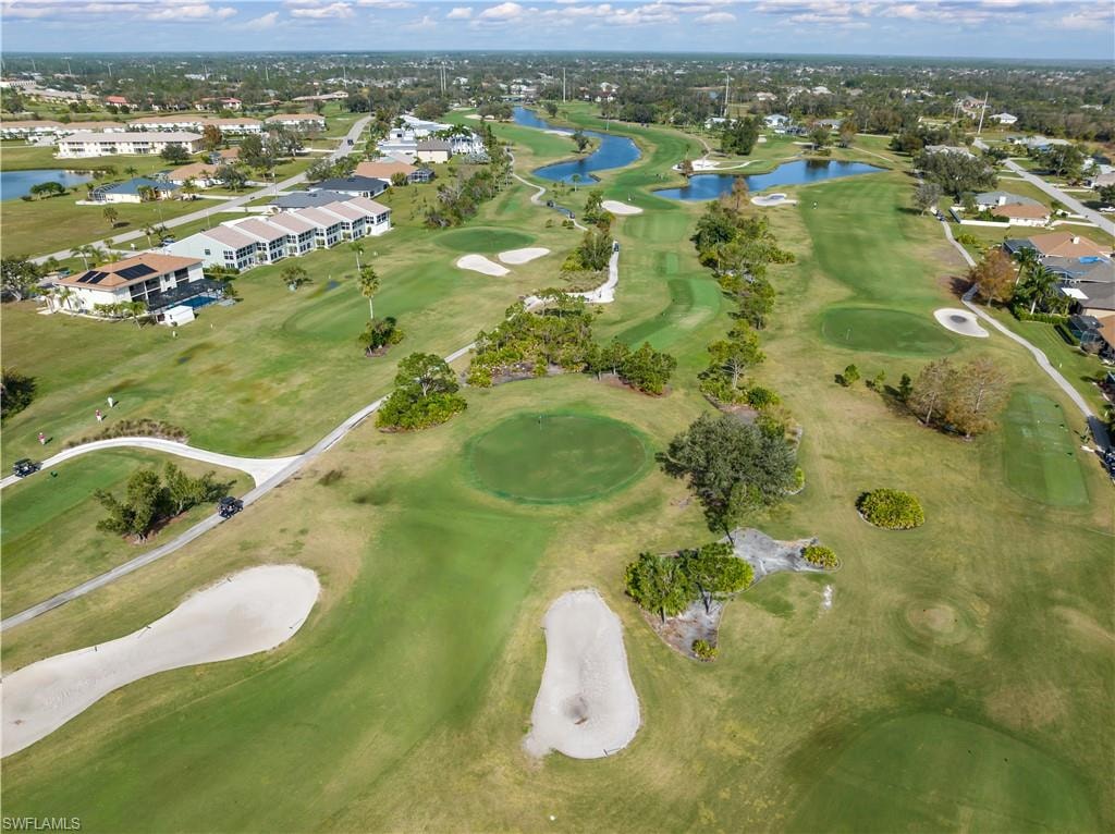 Aerial view of property's location with a large body of water and a golf club