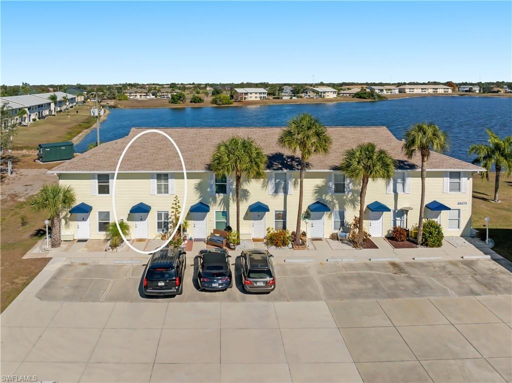 Aerial perspective of suburban area featuring a nearby body of water
