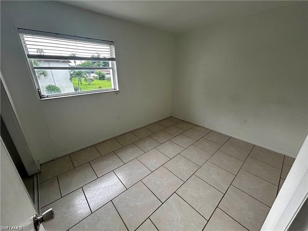 Unfurnished room featuring light tile patterned flooring
