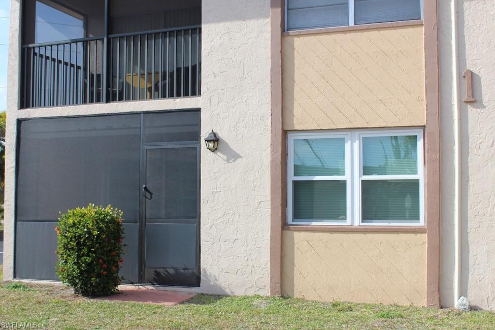 View of exterior entry featuring stucco siding
