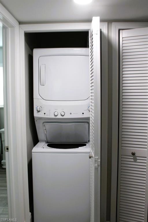 Laundry room featuring stacked washer and clothes dryer