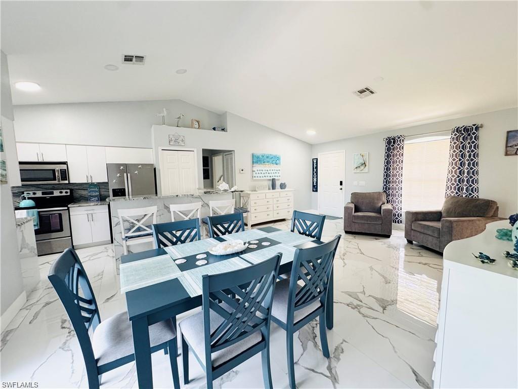 Dining area featuring recessed lighting and lofted ceiling