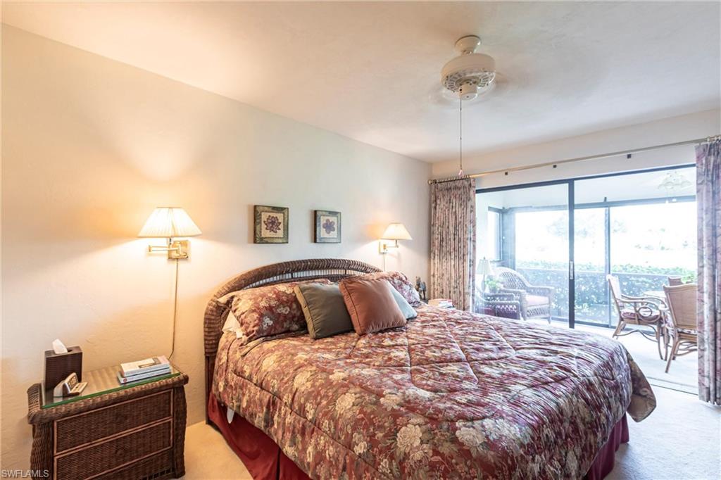 Primary Carpeted bedroom with access to exterior and a ceiling fan