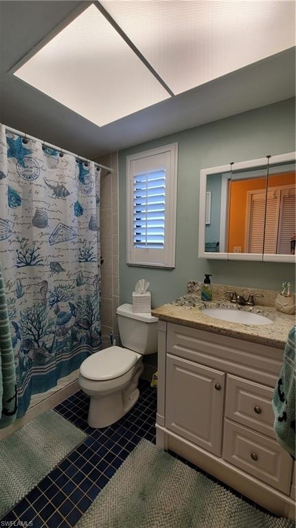 Full bathroom with vanity, tile patterned flooring, toilet, and a shower with curtain
