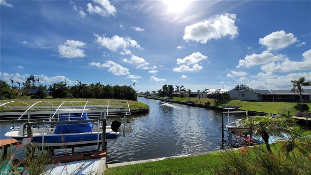 Dock area featuring a water view, a yard, and boat lift