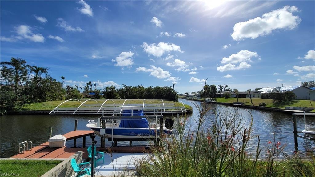 View of dock with a water view and boat lift