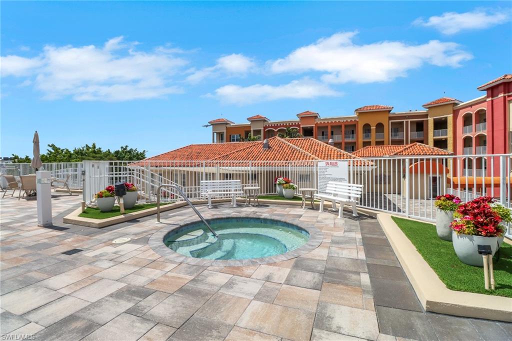 View of pool featuring a community hot tub, a pool, and a patio area