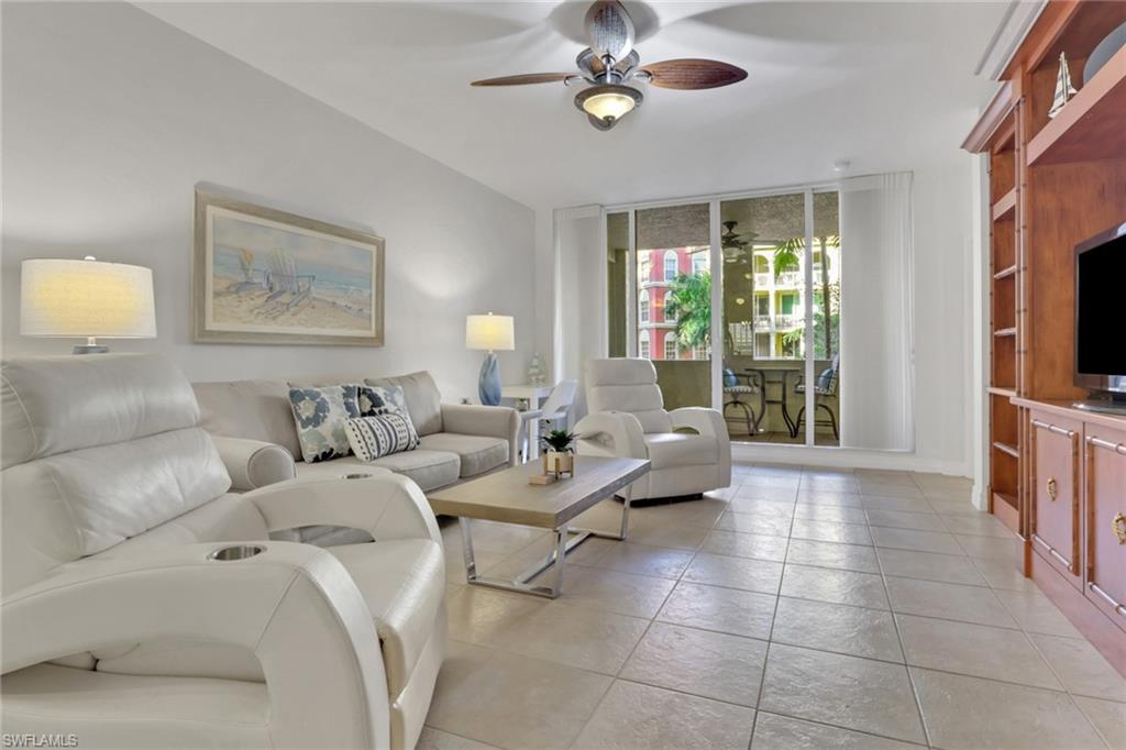 Living area with expansive windows and a ceiling fan