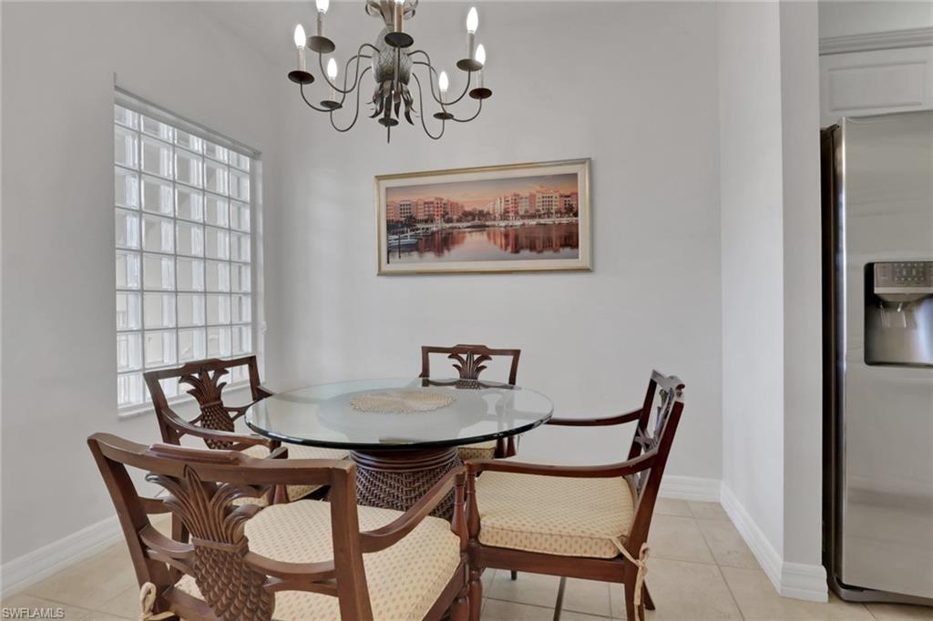 Dining room featuring light tile patterned flooring and a chandelier