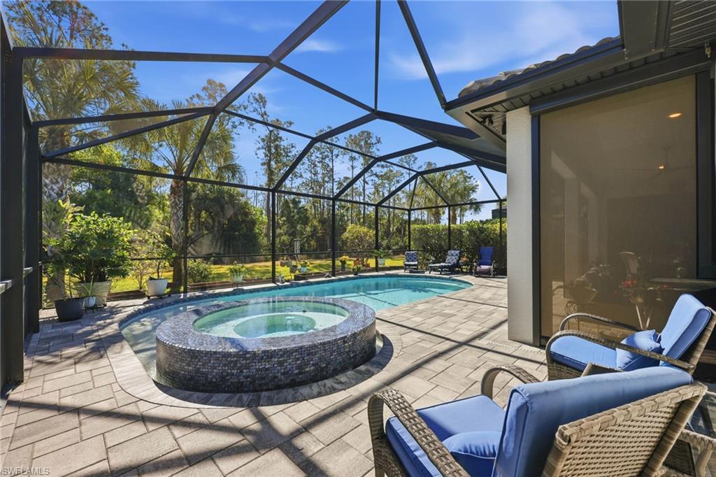 Integrated pool / spa featuring a patio, a lanai, and a sunroom