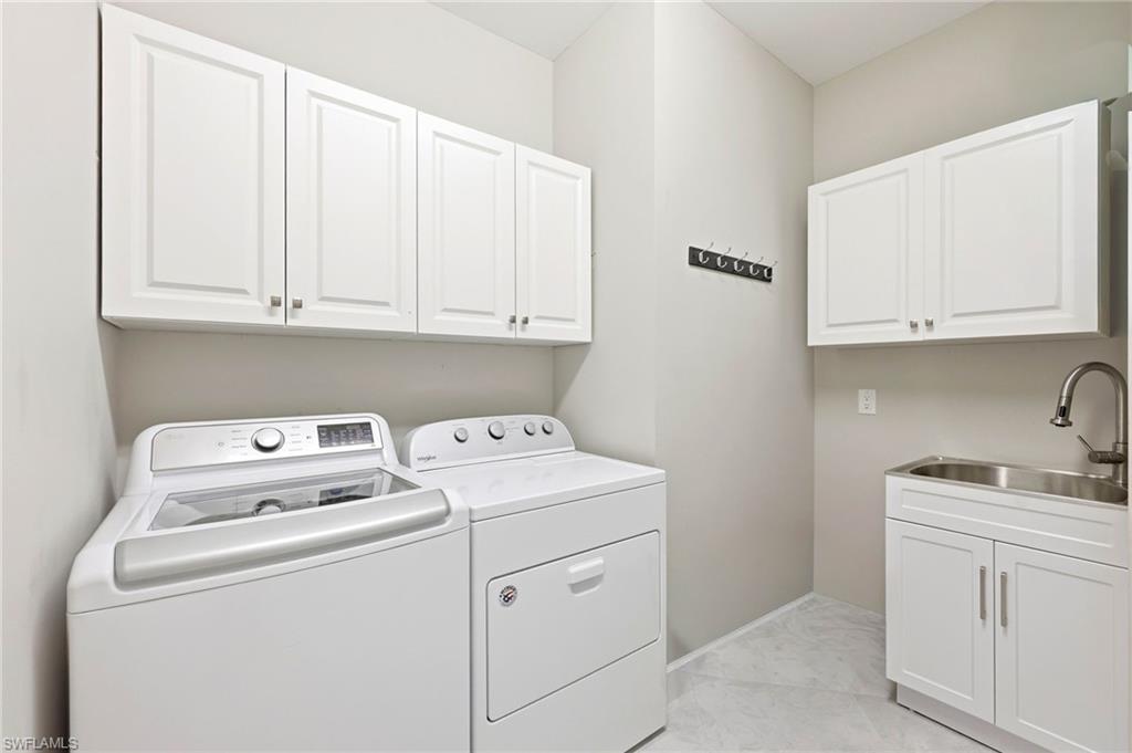 Laundry room featuring cabinet space and washing machine and clothes dryer