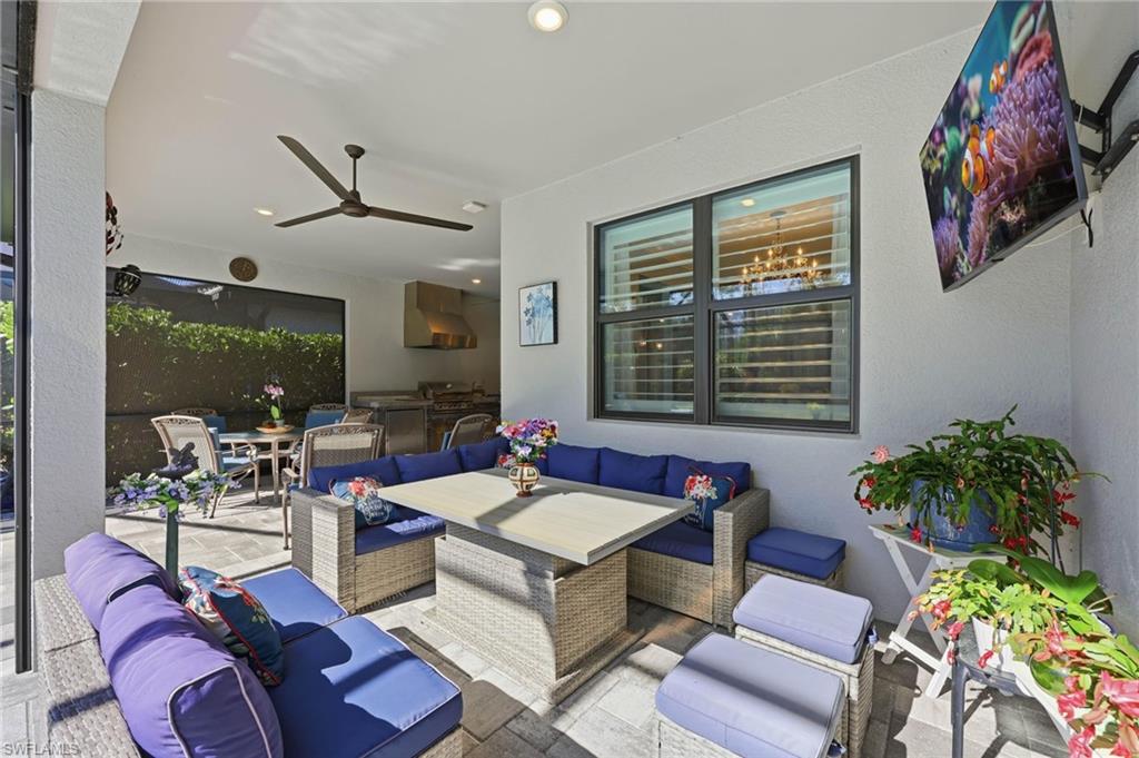 View of patio / terrace with an outdoor living / dining area, an outdoor kitchen, and ceiling fan