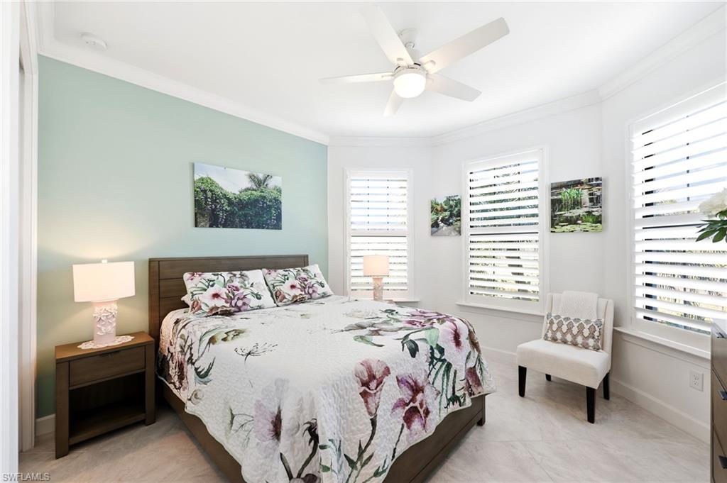 Bedroom with ceiling fan and ornamental molding
