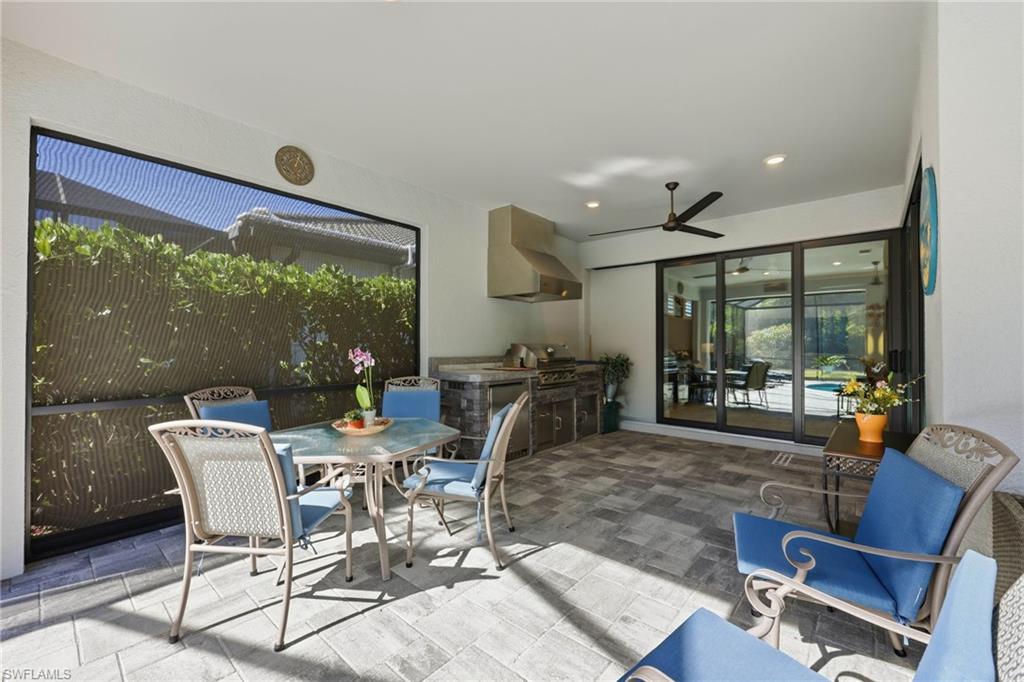 View of patio / terrace with an outdoor kitchen / dining area and ceiling fan