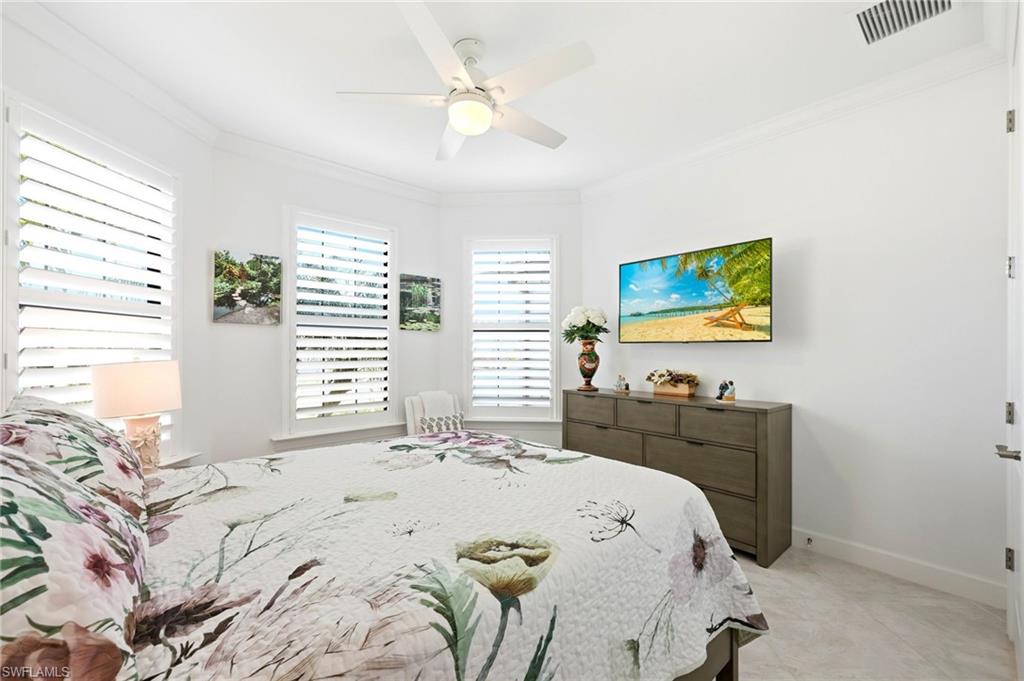 Bedroom featuring crown molding and a ceiling fan