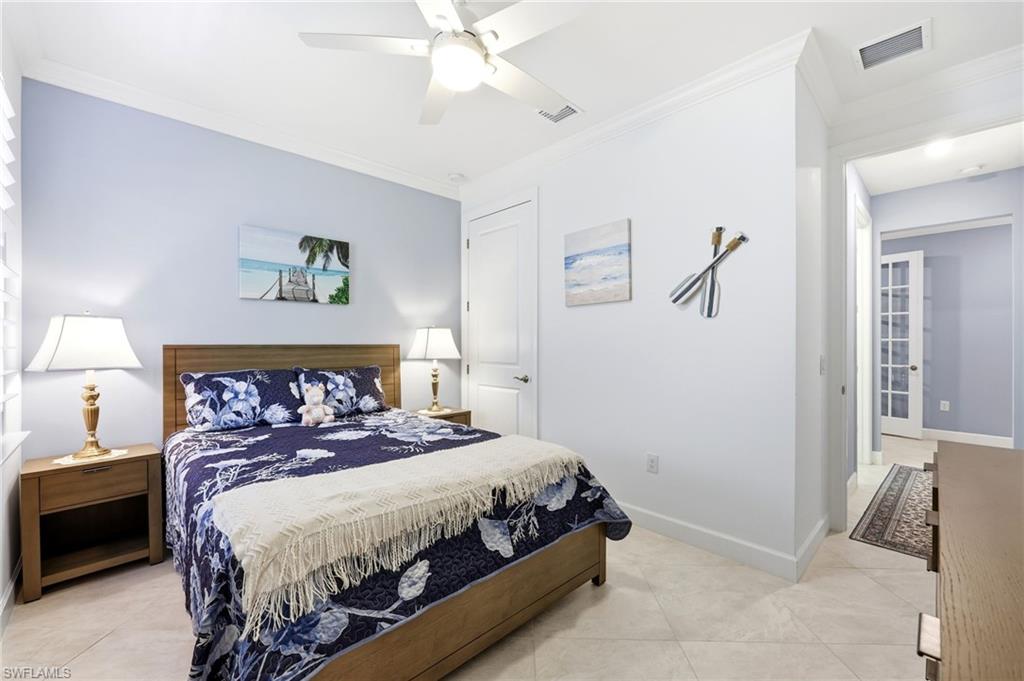 Bedroom featuring ornamental molding, ceiling fan, and light tile patterned floors