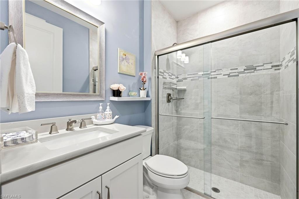 Full bathroom with a shower stall and vanity