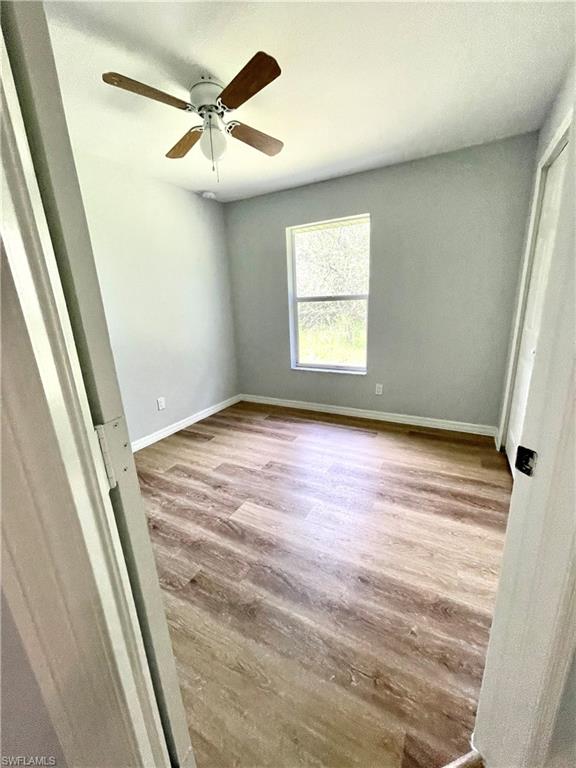 Unfurnished bedroom with wood finished floors and ceiling fan