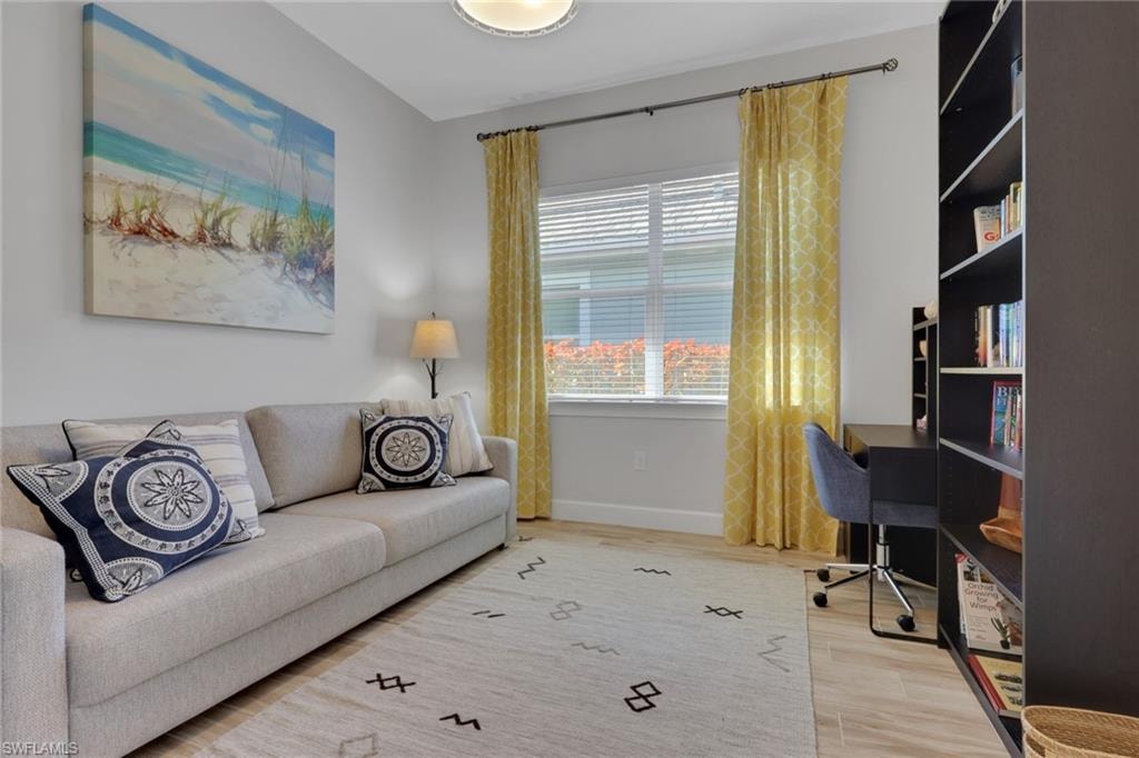 Home office with light wood-style floors and baseboards