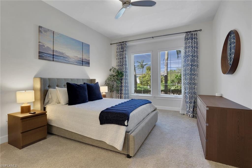 Bedroom featuring light colored carpet and ceiling fan
