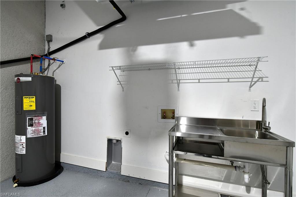 Laundry room featuring hookup for a washing machine, water heater, and electric dryer hookup
