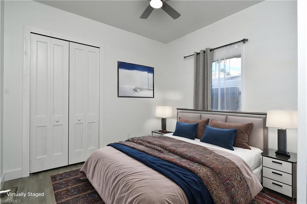 Bedroom with a closet, dark wood-style flooring, and ceiling fan