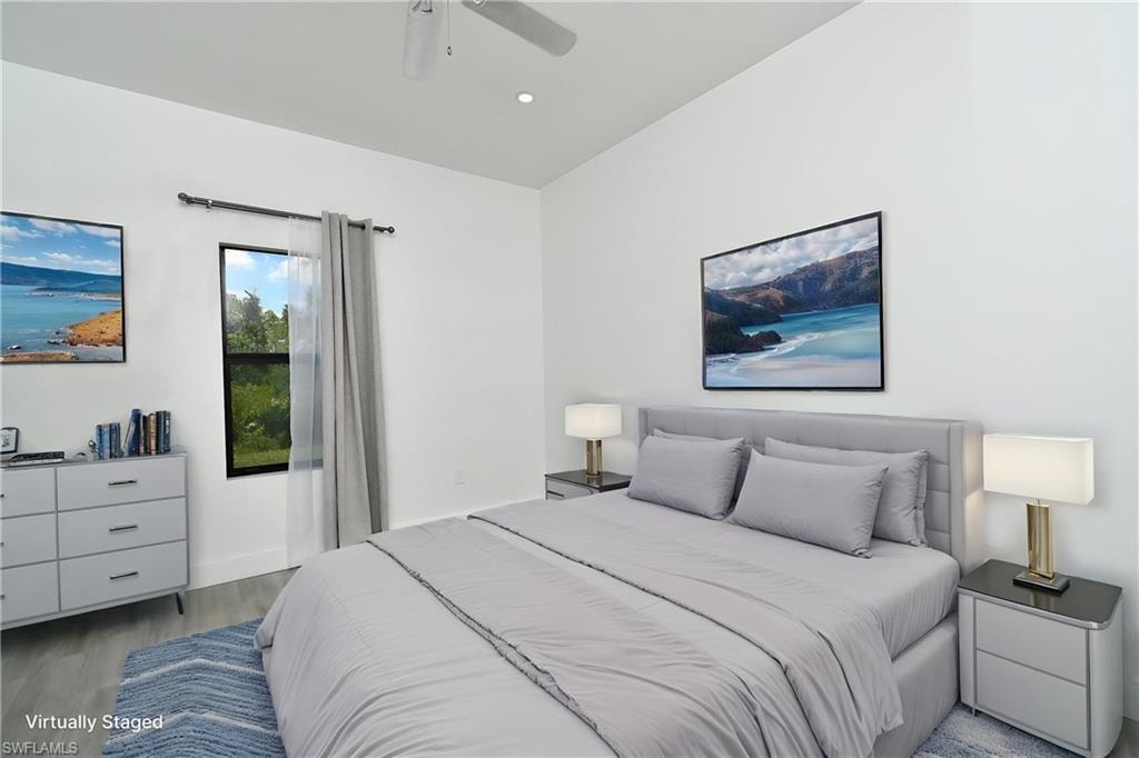 Bedroom with wood finished floors, ceiling fan, and recessed lighting