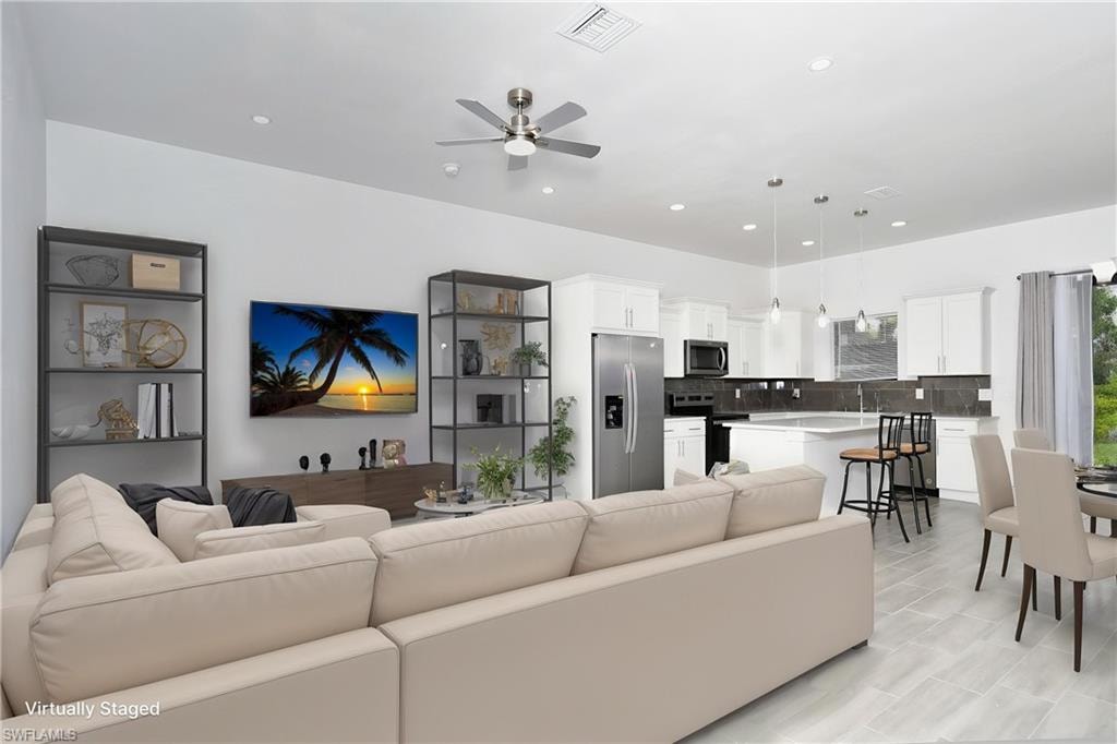 Living area with a ceiling fan and recessed lighting