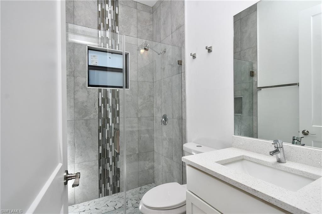 Bathroom featuring vanity and a stall shower