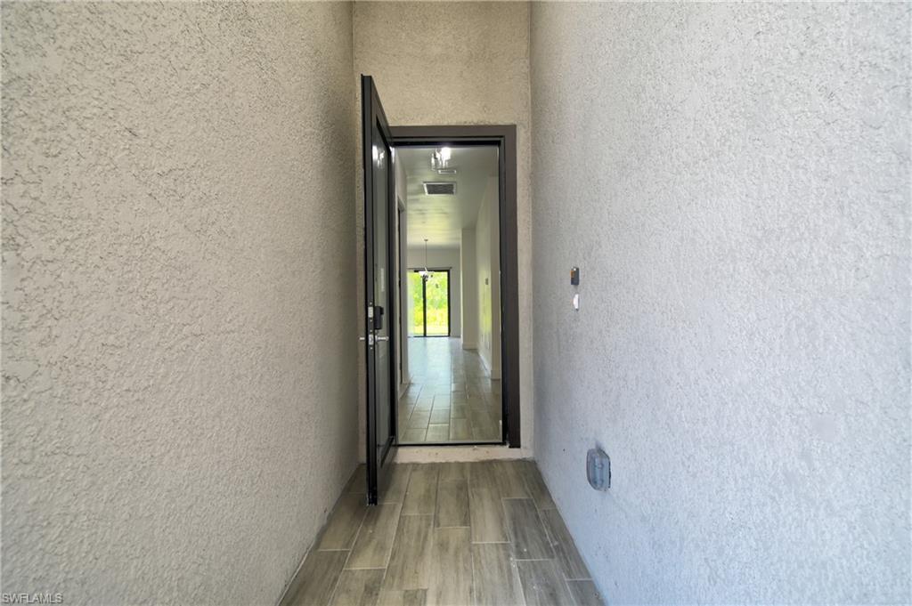 Entrance to property with stucco siding