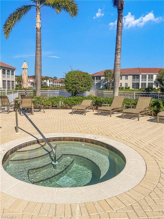 View of pool featuring a patio and a hot tub