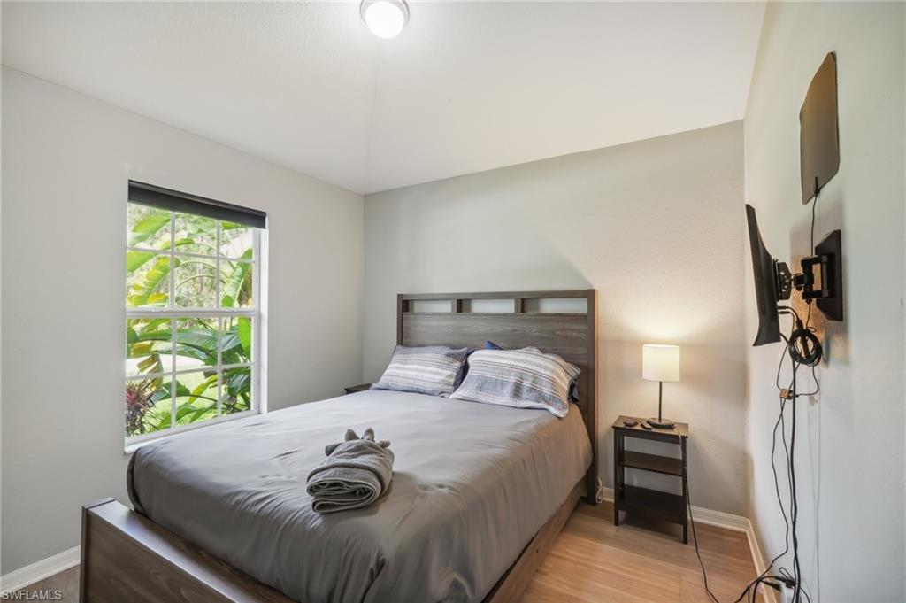 Bedroom featuring baseboards and wood finished floors