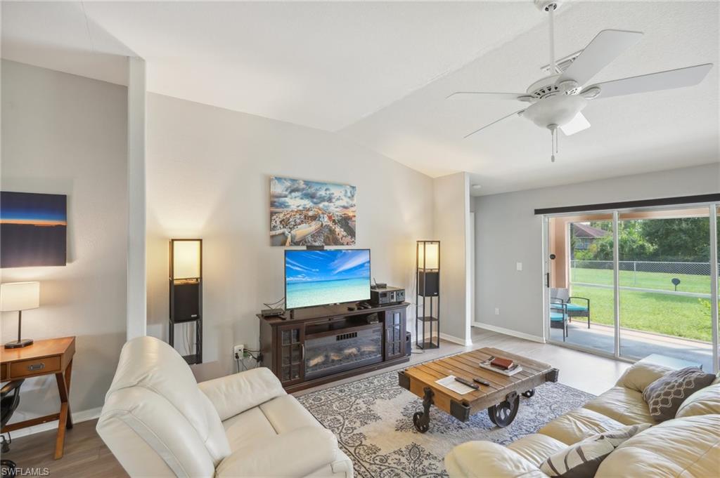 Living area featuring lofted ceiling, a ceiling fan, and wood finished floors