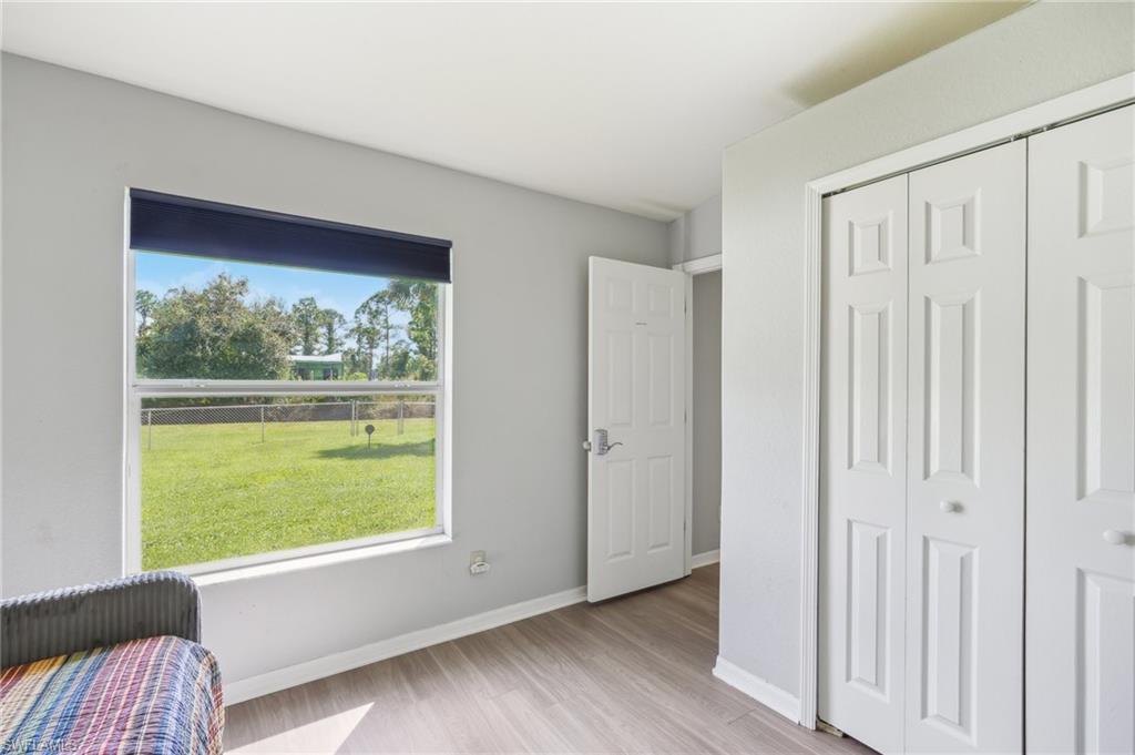 Bedroom with light wood-style floors and a closet
