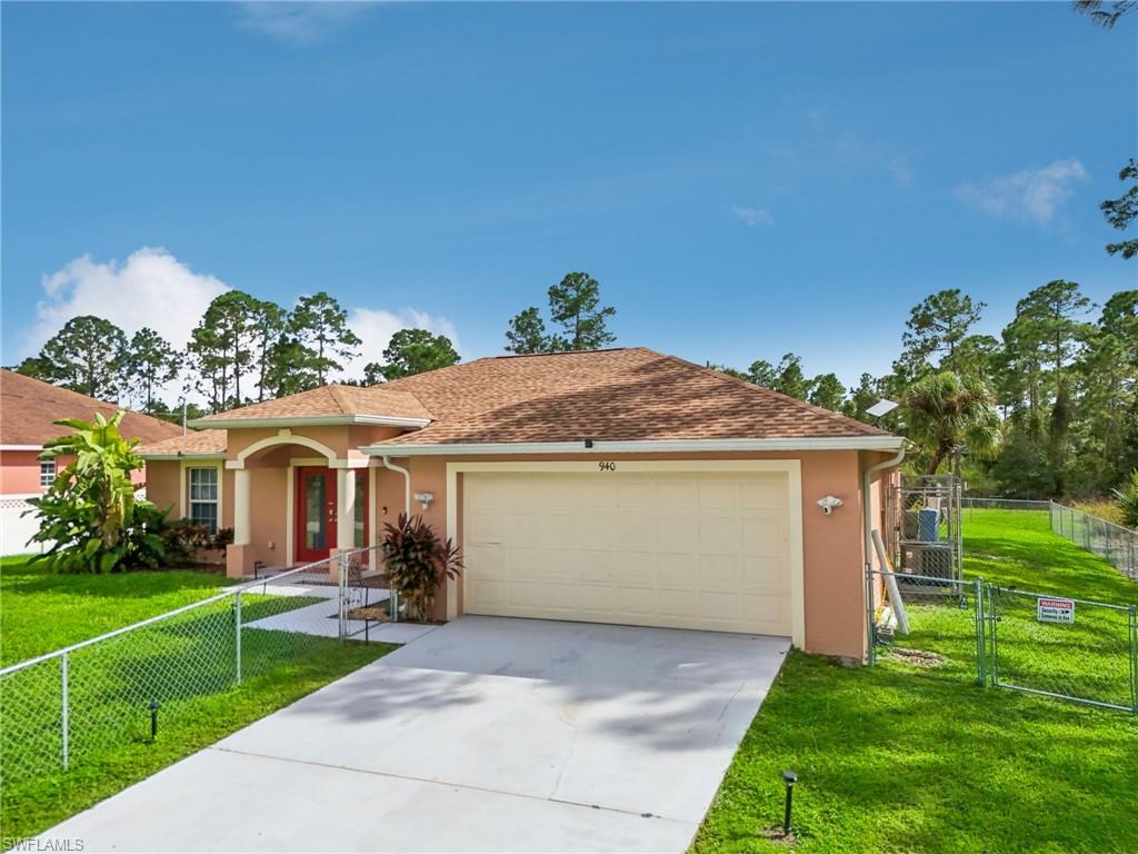 Single story home with a gate, stucco siding, concrete driveway, and a shingled roof