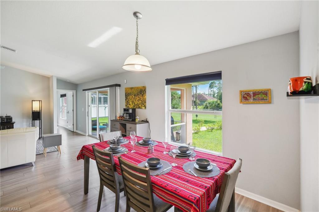 Dining room with light wood-style flooring and baseboards