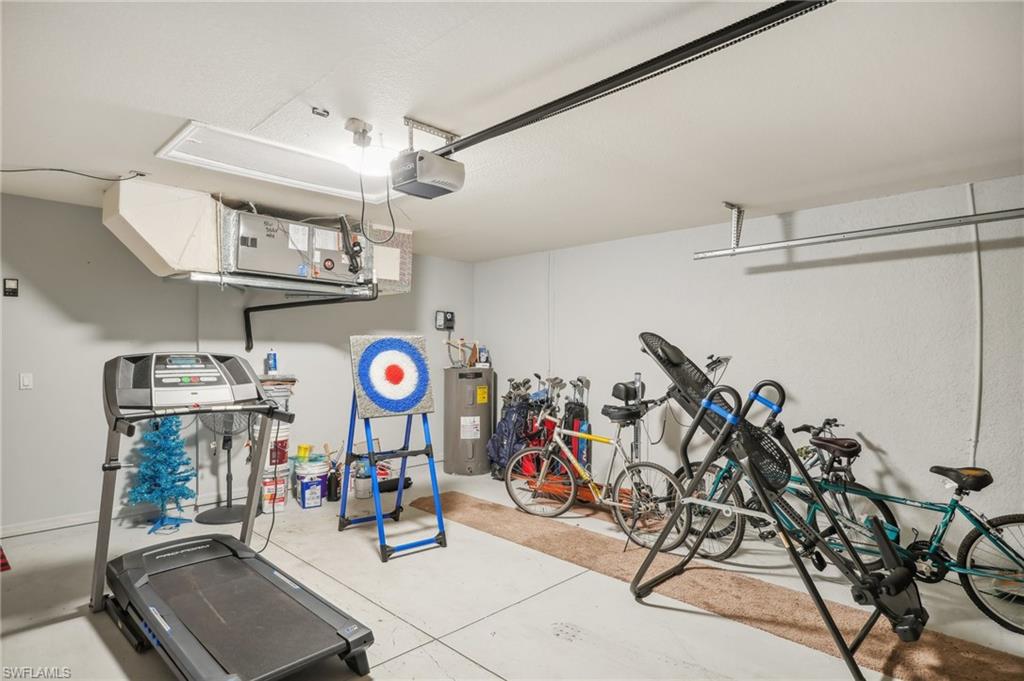 Garage with electric water heater and a garage door opener