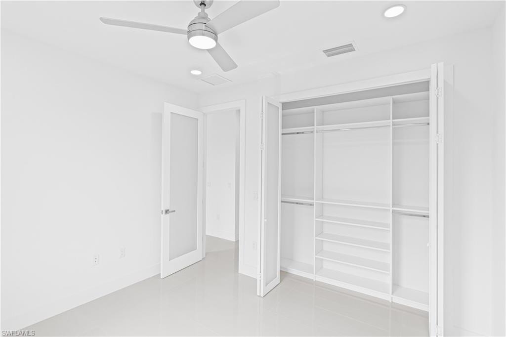Unfurnished bedroom featuring recessed lighting, a ceiling fan, and a closet