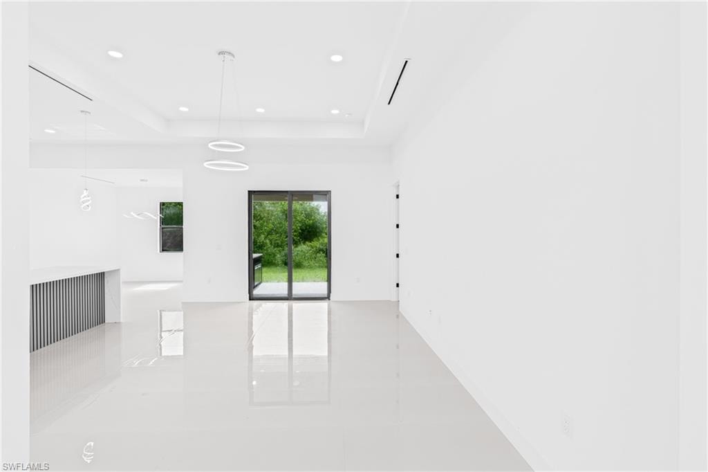 Spare room featuring recessed lighting and a raised ceiling